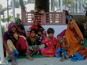 An Indian family, members of a lower caste due to their status as ethnic minorities, wait for a train.