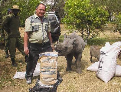 Rodrigues with feed and a rescued rhino calf